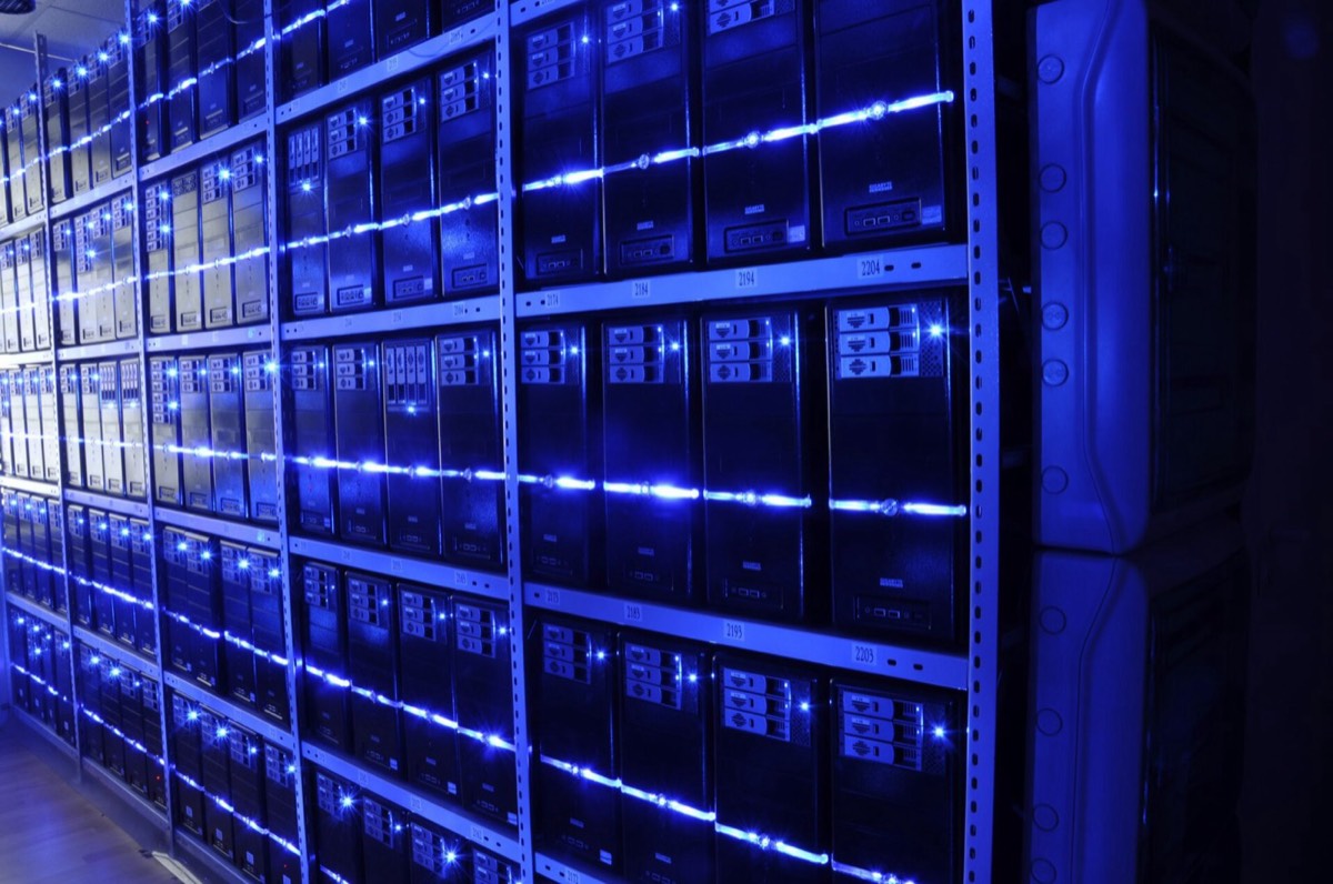 Rows of rack-mounted servers lit with blue light in a server room